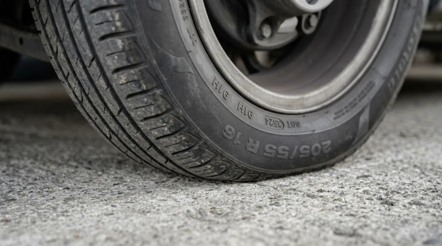 Pneu de voiture avec flat spot visible après stationnement prolongé sur parc de stockage